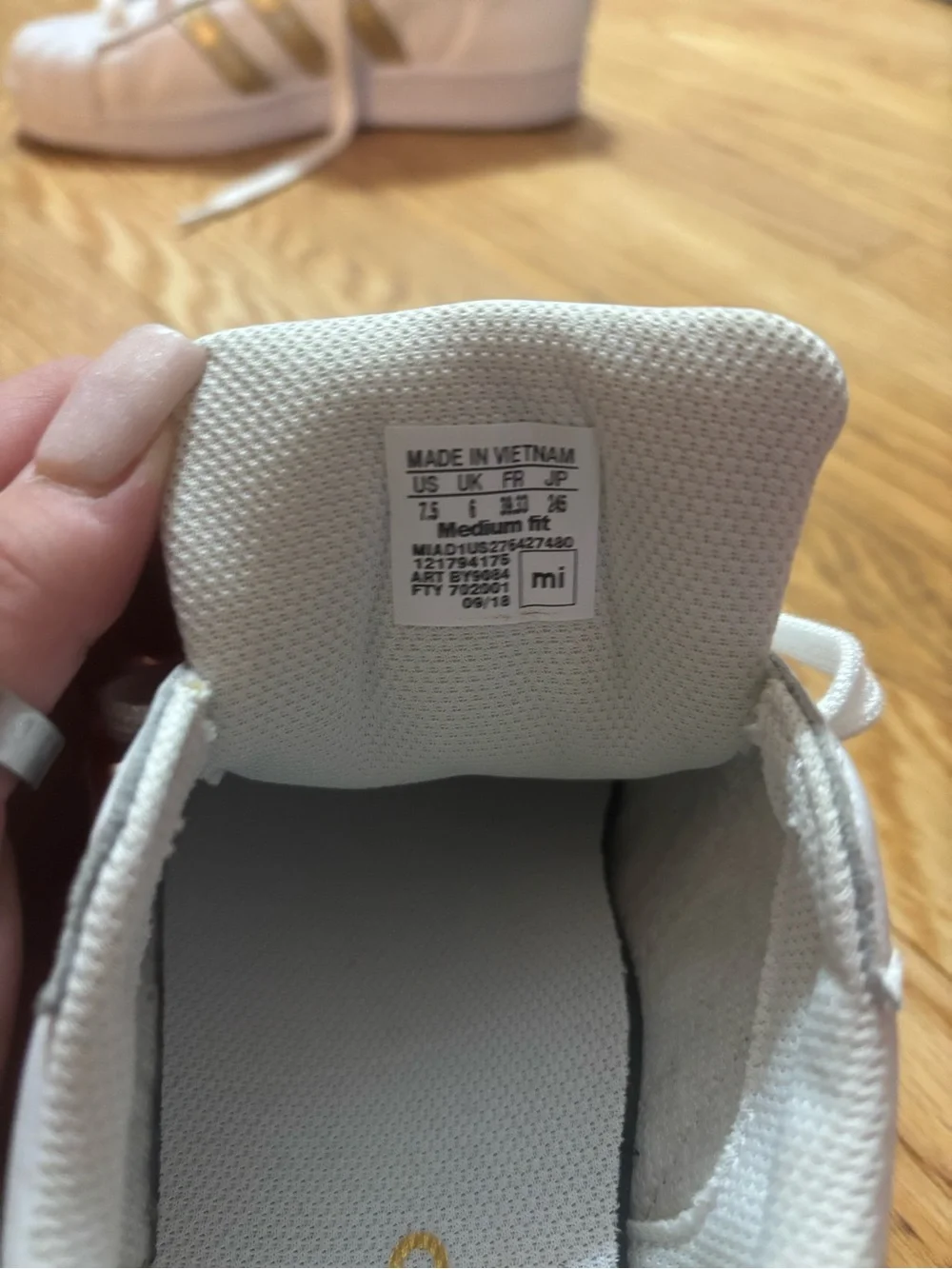 adidas Women's White Sneakers with Gold Stripe Accents